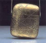 Hand-raised etched brass evening bag lined with silk velvet.