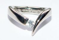 Wiggly ring - tension set 18ct white gold ring with 25pt diamond.