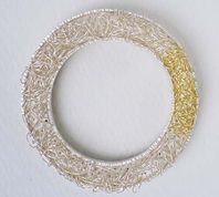 Circle brooch with loops.